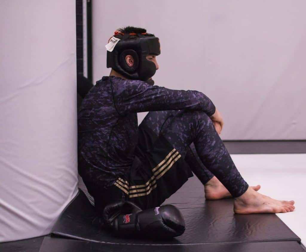 Fighter sitting alone on the mats