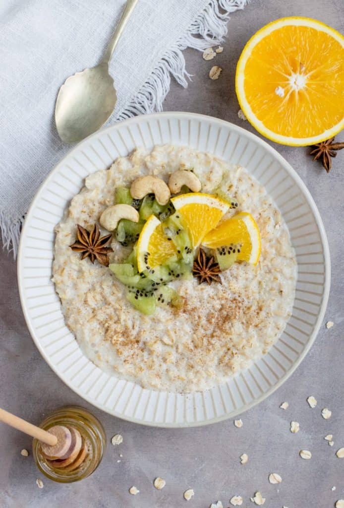 Oatmeal with kiwi, orange, cashews, and star anise