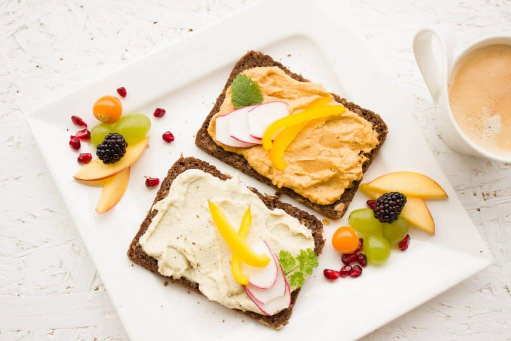 Rye bread with humus topped with fresh vegetables